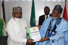 A.S. Adeleke Commandant NISS presenting a Souvenir to H.E. Alhaji Umar Abdullahi Ganduje