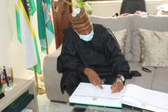 H.E. Prof Babagana Umara Zulum signing the visitors register